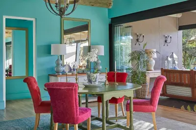 a dining room with a table and red chairs at Royal Malewane in Thornybush Game Reserve