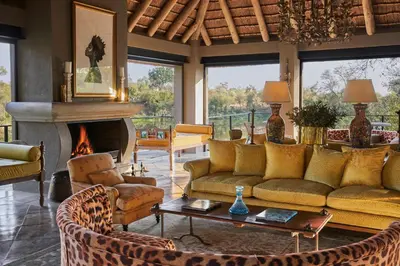 a living room with couches and a fireplace at Royal Malewane in Thornybush Game Reserve