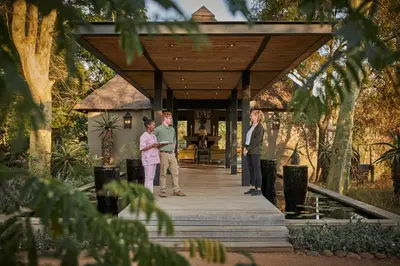 a group of people standing on a wooden walkway at Royal Malewane in Thornybush Game Reserve
