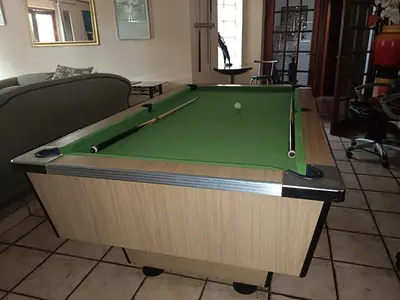 a green pool table in a living room at Jolly Suites in Midrand