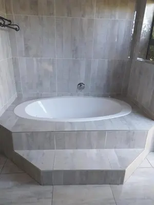 a large bath tub sitting in a bathroom at Budias Guesthouse B&B in Kempton Park