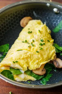 a omelet with mushrooms and greens in a pan at Budias Guesthouse B&B in Kempton Park