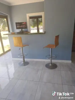two chairs sitting next to a counter in a room at Budias Guesthouse B&B in Kempton Park