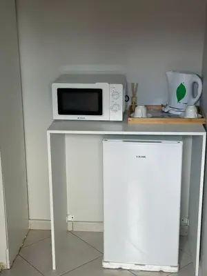 a microwave sitting on top of a white table at Safaya Inn in Kempton Park