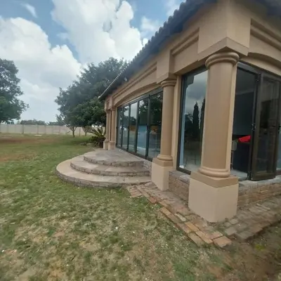 a house with large windows on the side of it at Mia's Accomidation in Kempton Park
