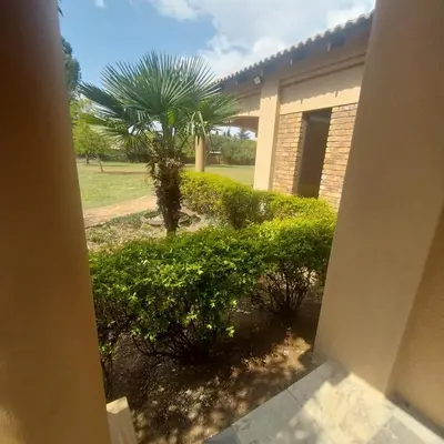 a palm tree in front of a building at Mia's Accomidation in Kempton Park