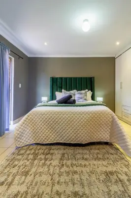 a bedroom with a large bed with a large rug at Meadow Lane in Johannesburg