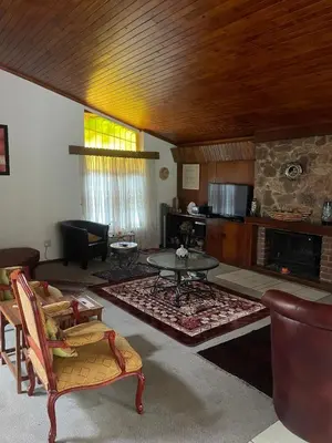 a living room with a table and a fireplace at The Ridge in Pretoria
