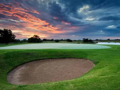 a sunset on a golf course with a hole in the grass at Euphoria Golf Estate House 196 Rooibok in Naboomspruit