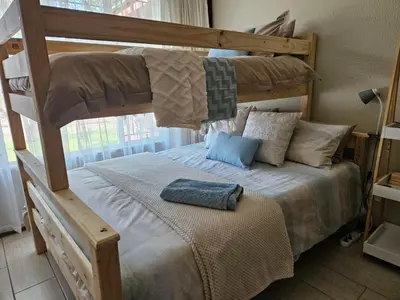 a bedroom with a bunk bed with a blue pillow on it at Krantz-Aloe guesthouse in Winterkamp