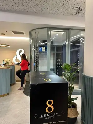 a woman is standing in a store with a display case at Your Oasis in Waterfall City in Midrand