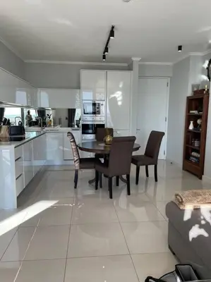 a kitchen and dining room with a table and chairs at Your Oasis in Waterfall City in Midrand