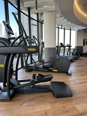 a gym with rows of treadmills and exercise bikes at Your Oasis in Waterfall City in Midrand