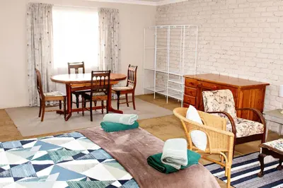 a living room with a table and chairs at Pecan and Lime Inn The Main Den in Pretoria