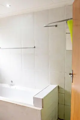 a bathroom with a tub and a shower stall at Pecan and Lime Inn The Main Den in Pretoria