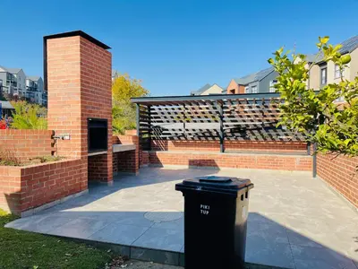 a trash can sitting in the middle of a patio at Secure 1 Bedroom Apartment in Midrand, Waterfall City - Lock Up and Go - Free WIFI and Parking - 4A Elizabeth Place in Midrand
