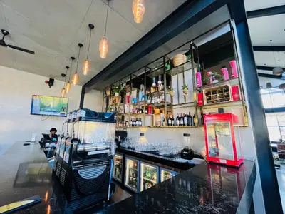 a bar in a restaurant with a counter at Secure 1 Bedroom Apartment in Midrand, Waterfall City - Lock Up and Go - Free WIFI and Parking - 4A Elizabeth Place in Midrand