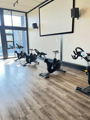 a row of exercise bikes in a gym with a whiteboard at Secure 1 Bedroom Apartment in Midrand, Waterfall City - Lock Up and Go - Free WIFI and Parking - 4A Elizabeth Place in Midrand