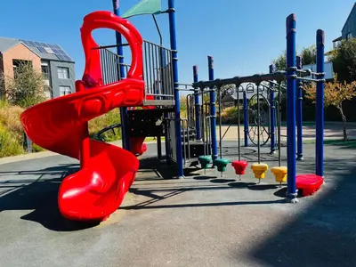 a playground with a red slide in a park at Spacious 2 Bedroom Apartment in Midrand, Waterfall City - Business and Family friendly - 13A Elizabeth Place in Midrand
