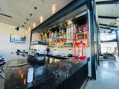a bar with a black counter and a red refrigerator at Spacious 2 Bedroom Apartment in Midrand, Waterfall City - Business and Family friendly - 13A Elizabeth Place in Midrand