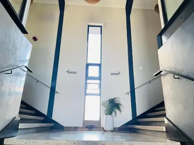 a stairwell with a plant in a vase next to a door at Spacious 2 Bedroom Apartment in Midrand, Waterfall City - Business and Family friendly - 13A Elizabeth Place in Midrand
