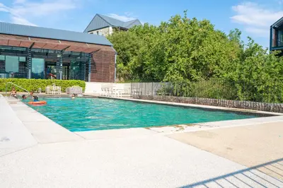 a swimming pool in front of a building at Spacious 2 Bedroom Apartment in Midrand, Waterfall City - Business and Family friendly - 13A Elizabeth Place in Midrand