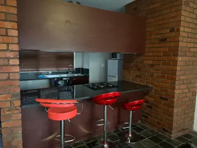 a kitchen with red bar stools and a counter at Angelic hut in Midrand