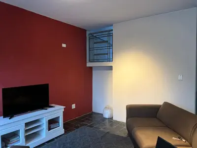 a living room with a couch and a flat screen tv at Angelic hut in Midrand