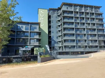 a large apartment building with a sign in front of it at One Bedroom Apartment at Circa in Pretoria