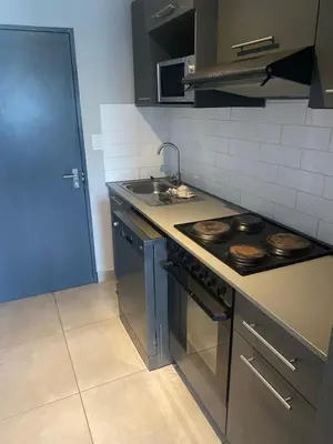 a kitchen with a stove and a sink at One Bedroom Apartment at Circa in Pretoria