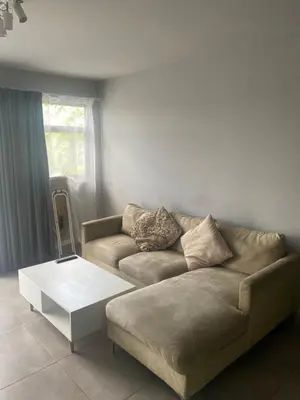 a living room with a couch and a coffee table at One Bedroom Apartment at Circa in Pretoria