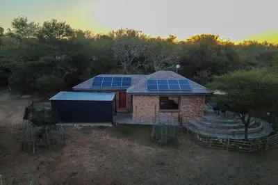 a house with solar panels on top of it at Finch Nest in Marloth Park