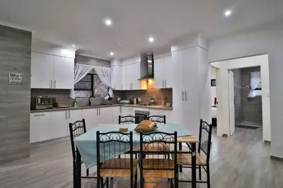 a kitchen and dining room with a table and chairs at Krokodil Rus in Marloth Park