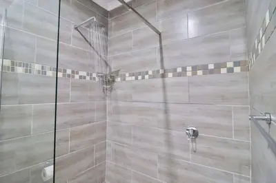 a bathroom with a shower with a glass door at Krokodil Rus in Marloth Park