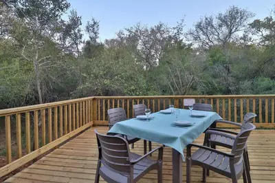 a table and chairs on a wooden deck at Krokodil Rus in Marloth Park