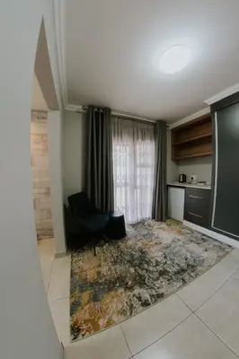 a living room with a rug on the floor at La Grace in Kempton Park