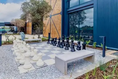 a chess board with a giant chess set on a sidewalk at Modern Retreat in Pretoria with Lagoon Pool & Gym in Pretoria