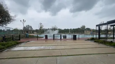 a parking lot with a fountain in the background at Modern Retreat in Pretoria with Lagoon Pool & Gym in Pretoria