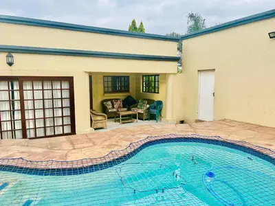 a large swimming pool in front of a house at BB Hers Cheesy in Midrand