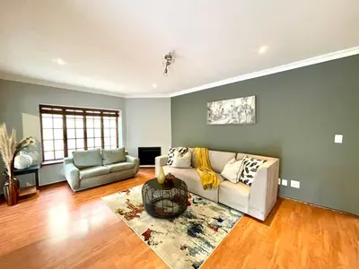 a living room with a couch and a chair at BB Hers Cheesy in Midrand