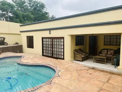 a house with a swimming pool in front of it at BB Hers Cheesy in Midrand