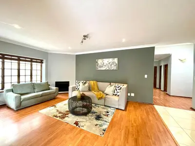 a living room with a couch and a rug at BB Hers Cheesy in Midrand