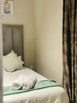 a bedroom with a bed with towels on it at Modern Retreat in Waterfall Midrand with Pool & Restaurant in Kyalami