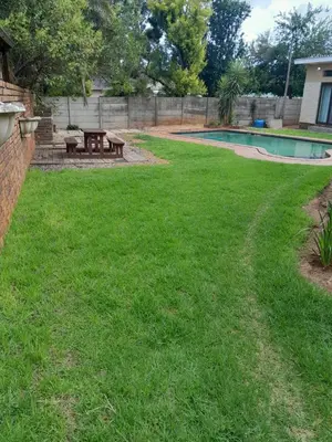 a yard with a pool and picnic tables at Transit Haven - 2 Bed Retreat in Kempton Park