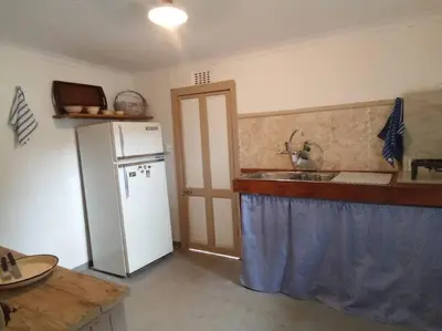 a kitchen with a white refrigerator and a sink at Church Mouse House in Pilgrimʼs Rest