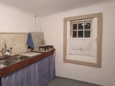 a kitchen with a sink and a window at Church Mouse House in Pilgrimʼs Rest