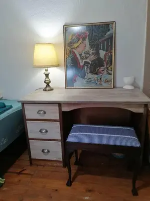 a desk with a picture and a lamp and a stool at Church Mouse House in Pilgrimʼs Rest