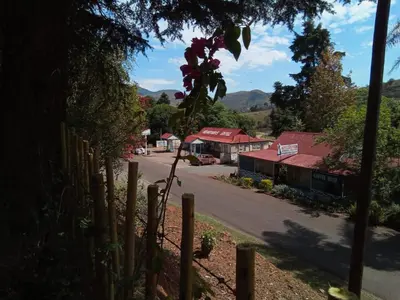 a view of a village with a fence and a street at Church Mouse House in Pilgrimʼs Rest