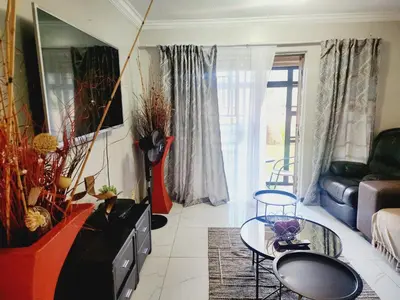 a living room with a couch and a table at Olympia in Pretoria