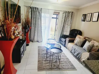 a living room with a couch and a table at Olympia in Pretoria